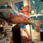 Denise Sirchie working on a sculpture of a fish in her studio