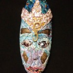 Oblong mask with blue face and gold crown