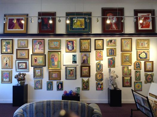 Photograph of gallery wall showing large number of Jerry Hammel's works