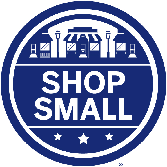 Round blue illustration of village above the words shop small
