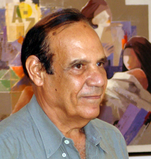 Artist Farooq Hassan in front of one of his paintings