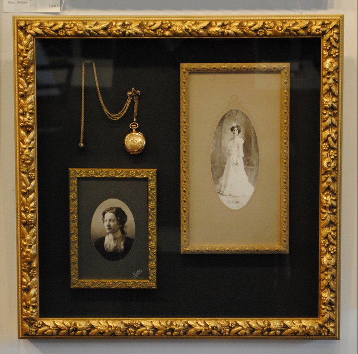 Shadow box with two antique photos of a woman and a pocket watch