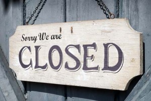 Wooden sign that says "Sorry, we are closed."