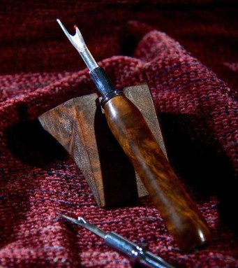 Seam ripper with hand-carved wooden handle.