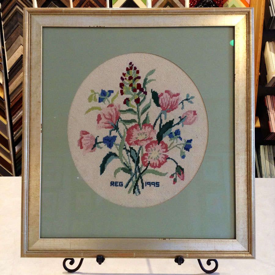 Colorful bouquet of embroidered flowers, matted and framed.