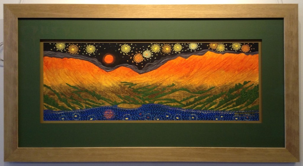 Colorful print of mountains under a starry sky.