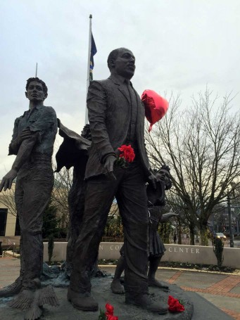 The Dream statue on Martin Luther King Day. Red carnations have been placed in King's hand and at his feet.