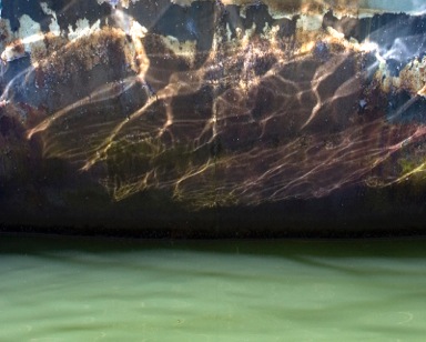 Encaustic painting of green sea water with stormy sky above