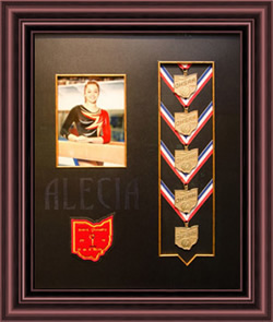 Shadowbox with gymnastic medals and picture of young gymnast