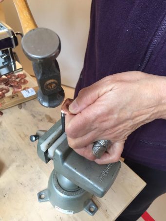 Close up of Amarinda Alpern's hands making jewelry