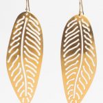 Gold earrings in the shape of a leaf.