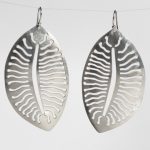 Silver earrings that look like a leaf
