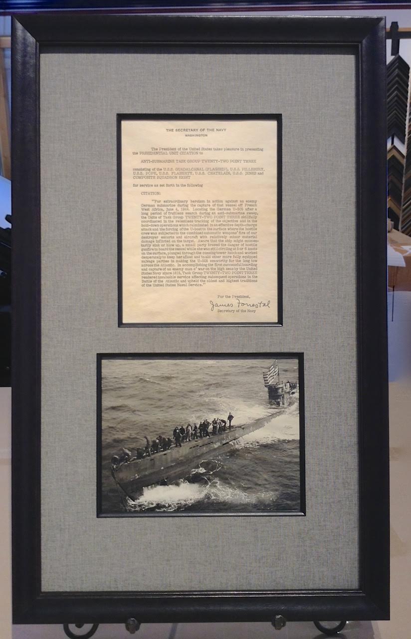 Presidential Unit Citation for the capture of U-505 during WWII and a photo of the US crew at sea framed together