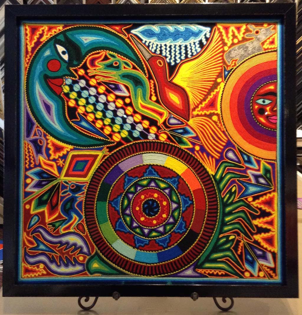 Brightly colored string art image of sun, moon, medicine wheel, maize, birds, and animals